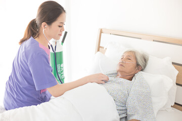 asian nurse screening old asian patient , elderly health check up , palliative care