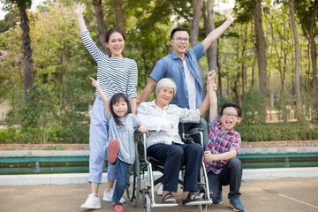 Obraz premium family times, asian children and asian adult relax in garden, mother day, old patient feeling happy with her family