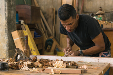 Entrepreneurial man doing his daily chores. Carpenter polishing wood and doing his daily chores....