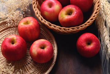 Red apple fruit in basket on wooden background, Healthy fruit