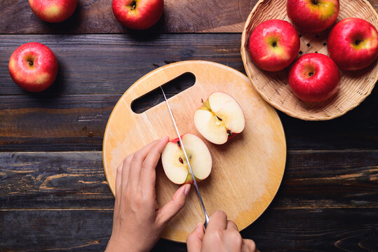 Red apple fruit cutting on wooden board, Healthy eating, Table top view
