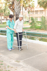 Asian old female train use walker with health worker, stroke patient use walker, walk training, rehabilitation process 