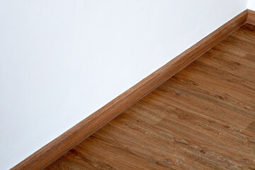 Naklejka na ściany i meble Laminate wood floor with blank white wall