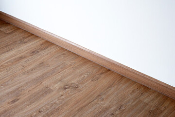 Laminate wood floor with blank white wall