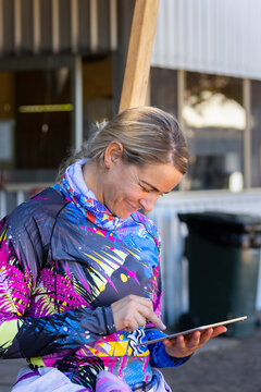 Woman In Colourful Shirt Tapping On Digital Tablet