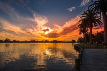 Fototapeta na wymiar Sunset reflections at Hamilton's Rotoroa Lake in New Zealand