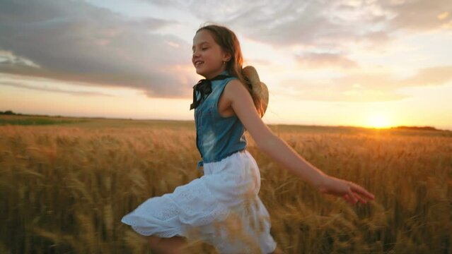 charming preteen girl is running on beautiful golden rye field in summer vacation, slow motion shot