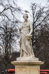 statue of Demeter marble in france park in autum