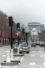 traffic in the city in the champs elysees paris with arch of triumph