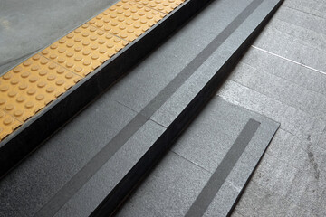 Black stairs and anti-slip sheet at the floor. 