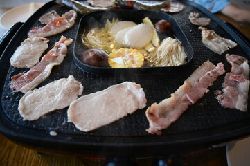 barbecue gril on black pot with meat and vegetable