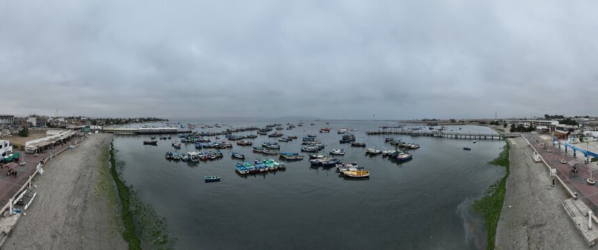 Paracas Port in Peru with the boats and city.