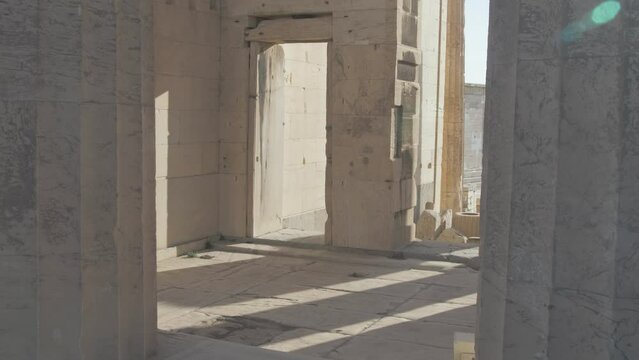 Sunlight shines through the pillars of the Propylaea