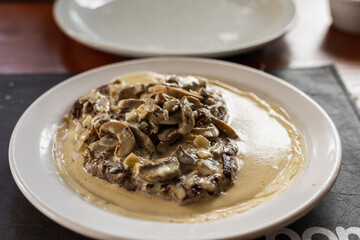 Fototapeta na wymiar plate of beef tenderloin champignon and cream in restaurant
