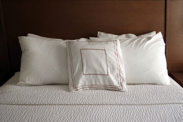 Fototapeta na wymiar Close view of white pillows on a freshly made hotel bed