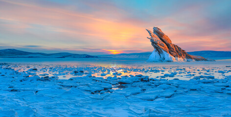 Ogoy island on winter Baikal lake with transparent cracked blue ice at sunrise - Baikal, Siberia, Russia