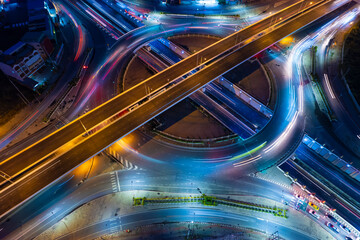 Hyperlapse time-lapse of car traffic transportation above circle roundabout road in Asian city....