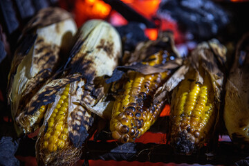 corn on the cob with chala roasted over a charcoal fire