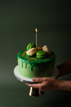 Hand Holding A Birthday Cake  With Candle