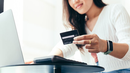 Young woman making payment and shopping by credit card, online business and home shopping concept.