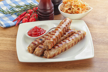 Grilled sausages with cabbage and sauce