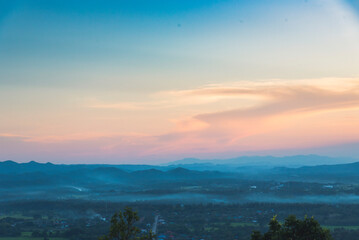 Naklejka premium Blue golden sky sunrise dramatic beautiful landscape mountain. Dawn sky gold dusk time cloudscape with sunlight. Dramatic sunset over mountain landscape. Beautiful landscape foggy hills twilight time