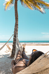 Beautiful Brazilian girl in the hammock on the beach in Tulum, Mexico
