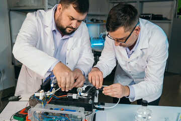 Young men are engaged in setting up a water purifier