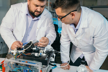 Young men are engaged in setting up a water purifier
