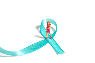 Miniature people figure toys photography. Ovarian and breast cancer awareness day concept. Girl,...