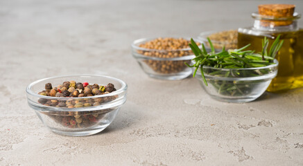 Various spices on the table, peppercorns in the foreground