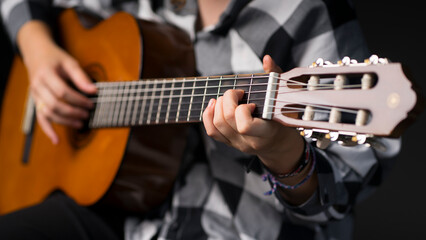 Fototapeta na wymiar Girl playing the guitar. Image with selective focus
