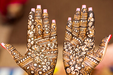 mehndi design on Indian bride's palm on her wedding eve.