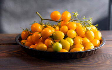Harvest of ripe juicy yellow tomatoes collected in clusters