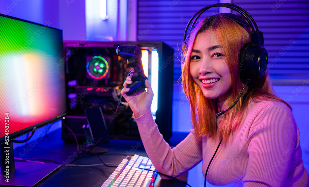 Poster smiling gamer using joystick controller for tournament plays online video game with computer neon li
