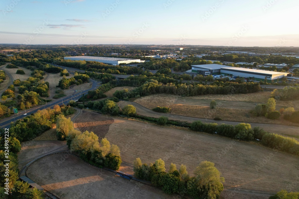 Wall mural Aerial View of Caldecotte Lake at Sunset, A beautiful lake split across 2 sides, drone's high angle footage of People and Landscape of England UK