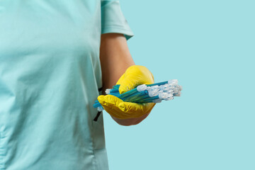 Dentist's hand in glove with saliva ejectors.