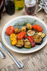 fried grilled vegetables in a gray plate on the table
