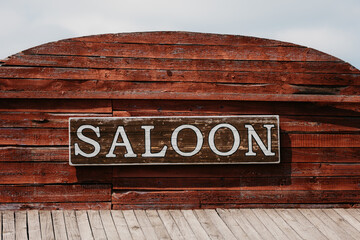 Saloon facade text in wild western city.