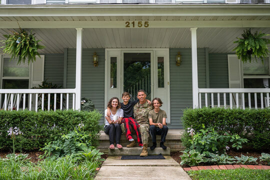 Air Force service member poses with family for group photo.