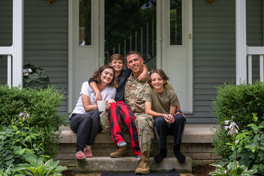 Air Force service member poses with family for group photo.