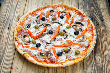 pizza with mushrooms, salami, pepper and olives
