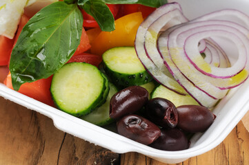 salad with fresh vegetables in a disposable dish
