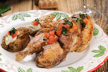fried chicken legs in a plate with potatoes

