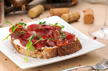 bruschetta with veal in a white plate
