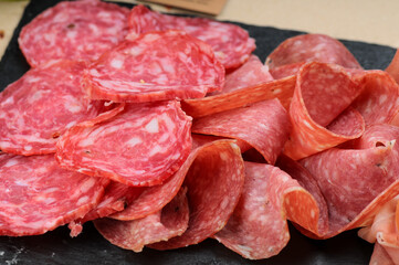 salami cut into slices in a plate macro photo
