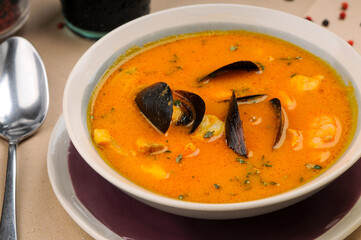 soup with mussels and squid in a plate
