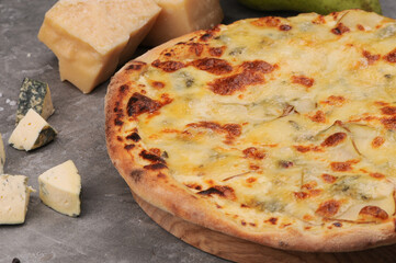 pizza crust and cheese with side dish on a gray background
