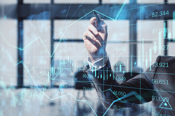 Fototapeta na wymiar businessman hand using and pointing at abstract glowing forex chart, map and arrows on index hologram, blurry office interior background, with digital pen.