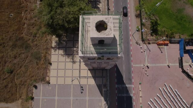 The White Mosque in Ramla, Israel, revealed by an overhead photograph showing the landscape around it, a white colored minaret, surrounded by a wide square